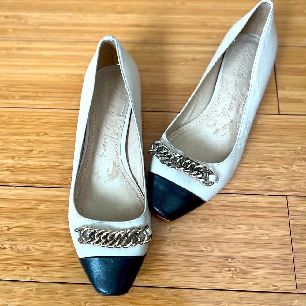 Two-tone flats with chain on toe area.